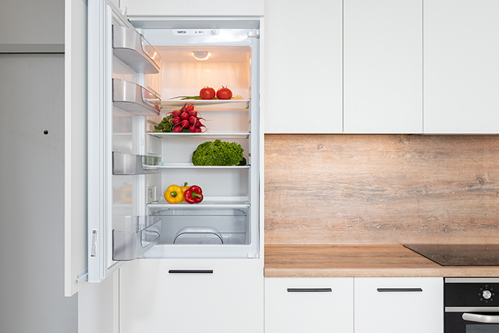 An open refrigerator door with food inside