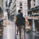 Two people walking down the aisles of a hardware store